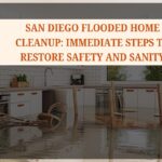 Homeowner using a wet vacuum during San Diego flooded home cleanup.